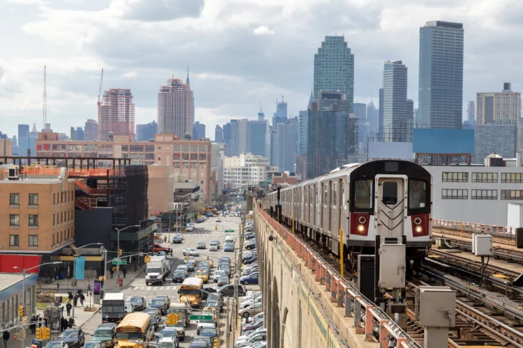 Subway Train Approaching Elevated Subway Station in Queens, New York